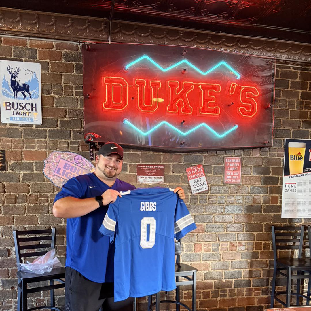 Duke's neon sign with Gibbs jersey and Lions gear
