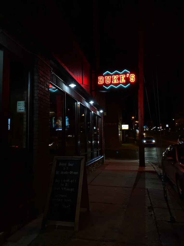 Duke's Social House neon sign illuminated at night